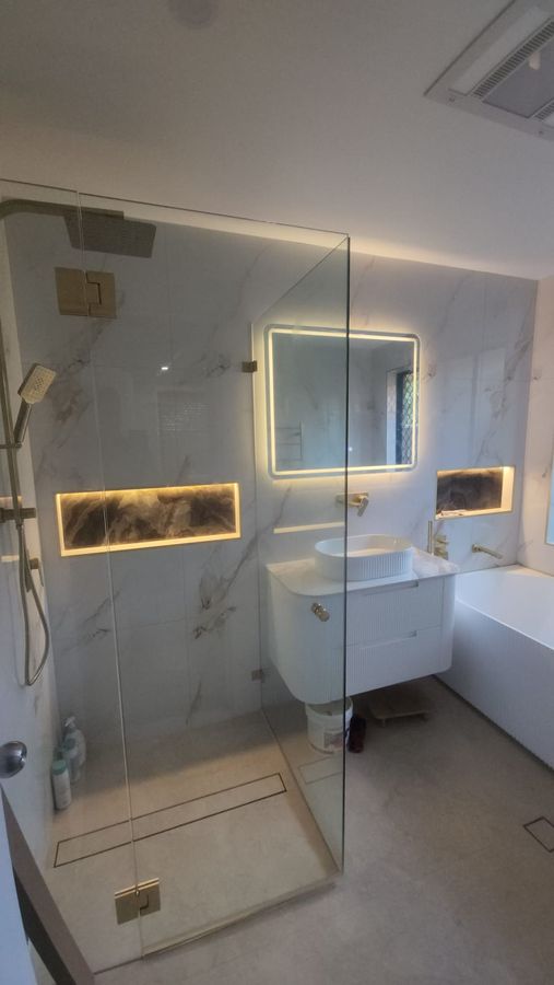 Bathroom with backlit LED mirror and niche lighting